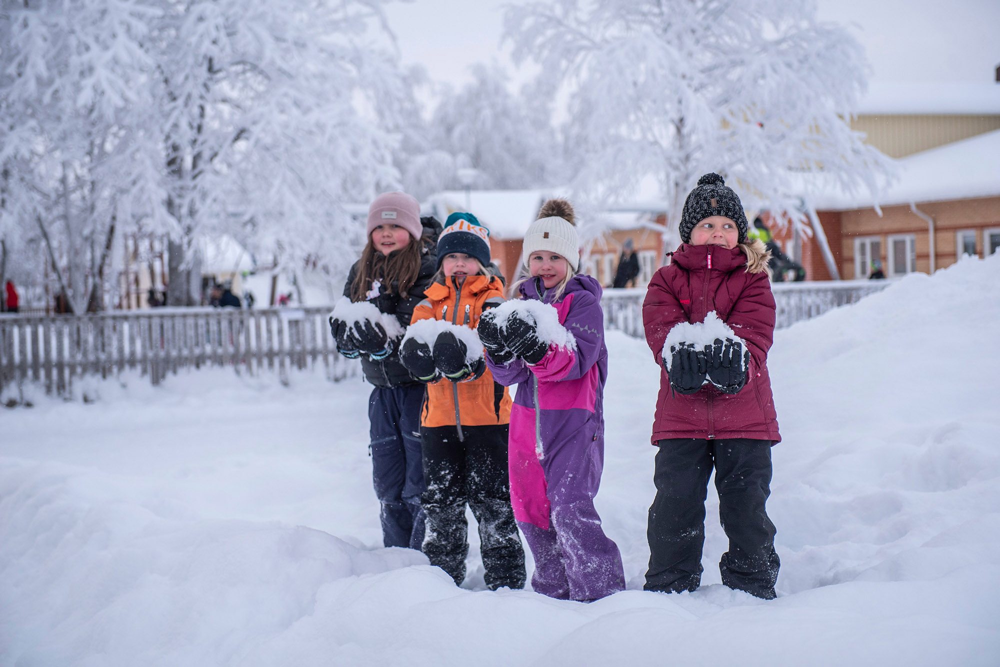 Flickor med stora snöbollar i famnen - lågstadieelever har rast utanför Smedskolan.